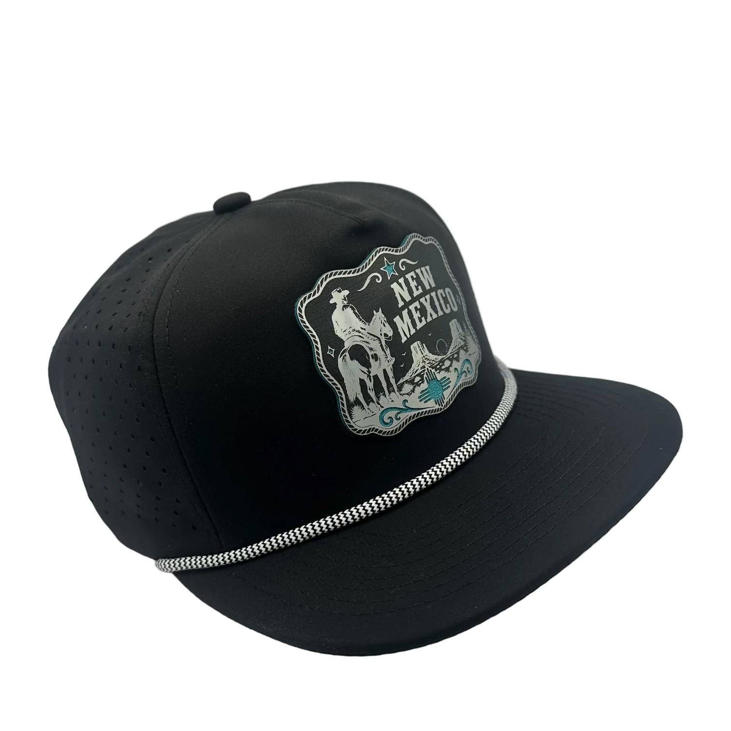 A black baseball cap with a curved brim, featuring a silver and white embroidered 'New Mexico' cowboy patch on the front and a silver decorative trim along the edge of the brim, set against a light gray background.